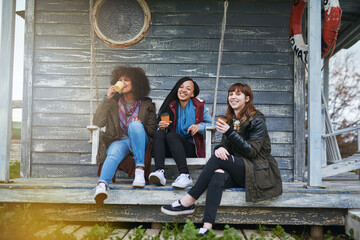 Aufkleber - The best of friends make the best of times. Shot of a group of friends sitting on the porch of a fishing cabin together.