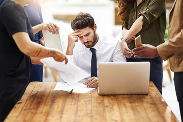 Poster - Im seriously so stressed out right now. Cropped shot of a stressed out businessman surrounded by colleagues needing help in an office.