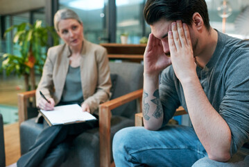 Canvas Print - I dont know what Im doing with my life. Shot of a young man having a therapeutic session with a psychologist and looking upset.