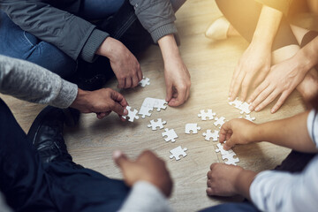 Poster - Start small and grow. Shot of a group of people building a puzzle together.