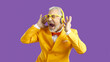 Overjoyed senior eccentric man in suit and glasses scream sing listen to music in wireless headphones. Funny old male have fun enjoy good quality sound in modern earphones. Technology concept.