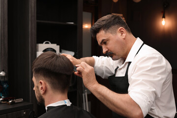 Sticker - Professional hairdresser making stylish haircut in barbershop