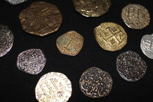 Spanish Pirate Coins Laid Out With A Black Background. 