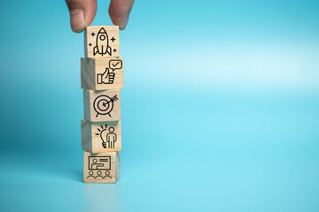 Businessman puts a wooden block of business symbols. Marketing and product planning ideas, startups, product manufacturing orientations.