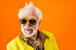 Leinwandbild Motiv Cool senior man with fashionable outfit portrait - Funny old male person with cool and playful attitude on colorful background