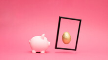 Pastel Pink Piggy Bank With Golden Egg. Concept Of Saving, Accumulating And Preserving Money.