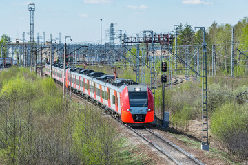 Wall Mural - Passenger train moves at summer morning.