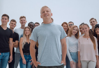 Wall Mural - smiling leader standing in front of a casual group of young people