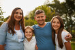 © Lyndon S/peopleimages.com - This is what family looks like. Cropped portrait of a young family of four standing outside.