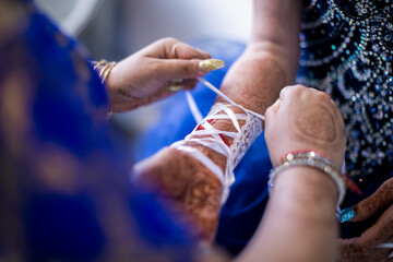 Indian bride's hands, gloves, rings, mehendi and jewellery close up