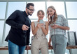 © ASDF - business team looking at the screens of their smartphones