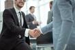 © ASDF - happy young businessman shaking hands with his business partner
