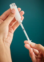 Canvas Print - The perfect dose of insulin. Cropped shot of an unrecognizable woman drawing a dose of insulin into a syringe at home.