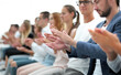 © ASDF - group of young people applauding sitting in the conference room.