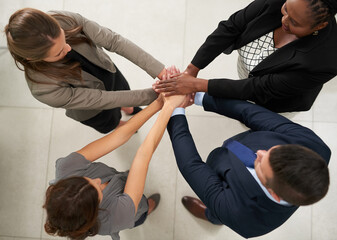 Aufkleber - Determined to realise their goals together. High angle shot of a group of businesspeople joining their hands together in unity.