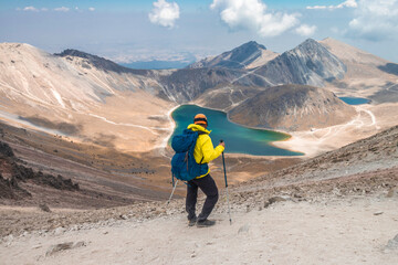 a mountaineer contemplating the volcanic lakes of the crater of the nevado de toluca in mexico