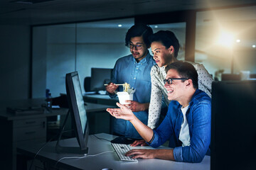 Sticker - Working the late shift. Shot of a group of programmers working together on a computer in the office at work during the night.