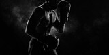 Noname image of a kickboxer on a dark background. The concept of mixed martial arts.