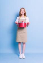 Image Of Young Asian Woman Holding Pot On Blue Background