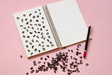Latin Letters Are Scattered On The Page Of A Notebook In A Mess, Learning Foreign Languages, Creativity Concept