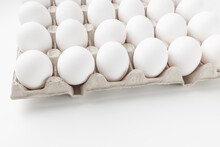 Fresh raw 30 pack of large white eggs in cardboard on white background. Consumerism, egg production, organic healthy bio product and Easter holiday concept, copy space