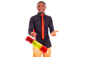 Wall Mural - young business man holding a broom smiling.