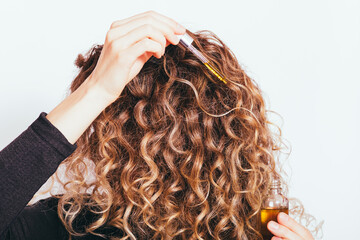 Wall Mural - Close-up young woman applying natural oil