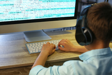 Cute little programmer using modern computer at home