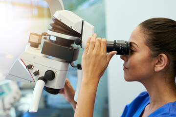 Aufkleber - Taking a closer look. Shot of a young pathologist looking at samples under a microscope.