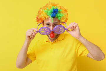 Poster - Funny young man in disguise on yellow background. April fools' day celebration