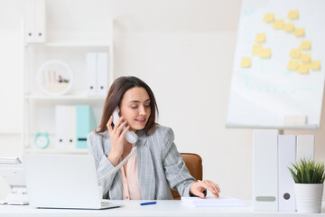 Poster - Young secretary talking by phone while working in office