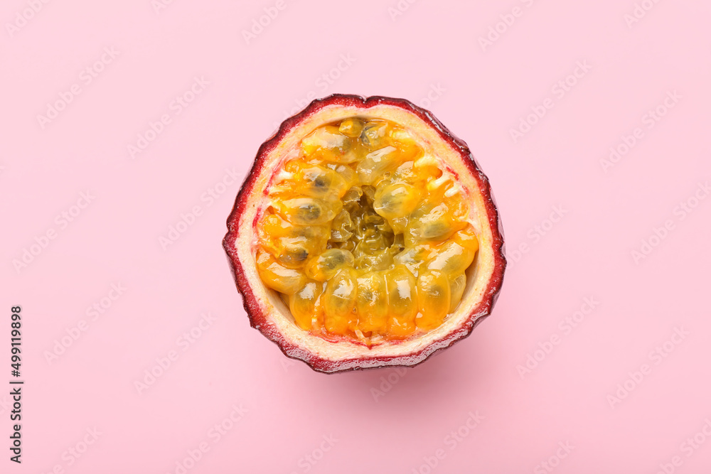 Delicious cut passion fruit on pink background
