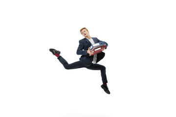 Young man in dark business suit jumping, flying isolated on white background. Art, motion, action, flexibility, inspiration concept.