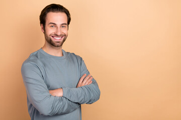 Wall Mural - Photo of young man cheerful man smart crossed hands agent leader isolated over beige color background