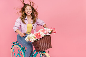 Poster - Photo of cheerful charming pretty lady drive bike wind blow hair wear jacket isolated pink color background