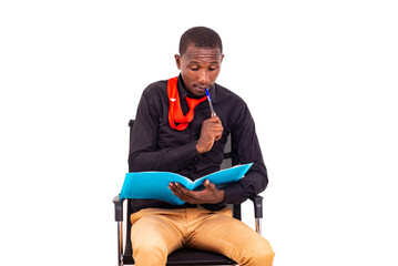 Poster - young business man sitting and thinking about what to write in the document.