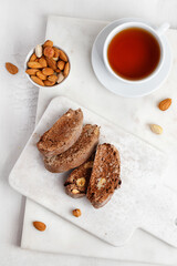 Italian chocolated cantucci with almond and hazelnuts. Biscotti cookies with nuts and cup of tea. Homemade biscotti.