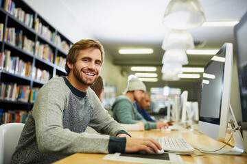 Canvas Print - I work hard so that I can play hard. Cropped portrait of a young male university student studying in the library.