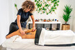 © Aitana fotografia - masseuse doing a wood therapy massage