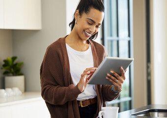 lets see if my favourite store has any new arrivals. shot of a young woman using a digital tablet at