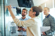 © Adene Sanchez/peopleimages.com - Everything becomes clearer once you puzzle through it. Shot of a group of businesspeople brainstorming with notes on a glass wall in an office.