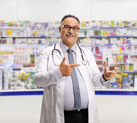 Poster - Doctor holding a glass of water and pointing in a pharmacy