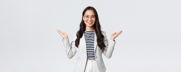 Wall Mural - Business, finance and employment, female successful entrepreneurs concept. Professional enthusiastic businesswoman in white suit and glasses raising hands up, greeting clients in office