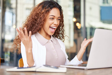 Canvas Print - Dreams can come true. Shot of a young businesswoman looking excited while using a laptop at a cafe.