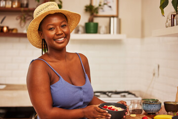 Wall Mural - I dont quit when the bets are down. Portrait of a young beautiful woman wearing a sunhat while preparing breakfast at home in the kitchen.