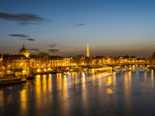 Pont des Arts bridge over River Seine and eiffel tower at night