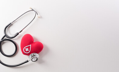 World blood donor day, red cross and nurse day concept made from red heart and stethoscope on white background.