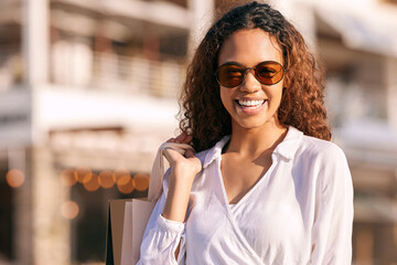 Sticker - Its time for some retail therapy. Shot of an attractive young woman standing alone outside while shopping in the city.