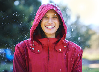 Sticker - Dont let bad weather ruin your day. Shot of a young woman enjoying the rain outside.