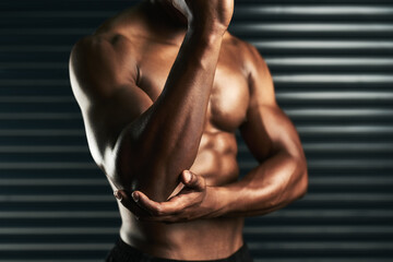 Sticker - Strengthen the muscles around your joints. Studio shot of an unrecognizable man examining an elbow injury during his workout.